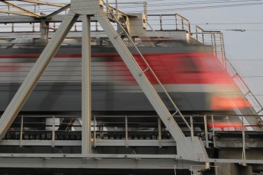 Railway bridge and train rides fast, blurred clipart