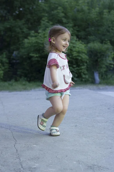 Little girl running in the park in the evening — Stock Photo, Image