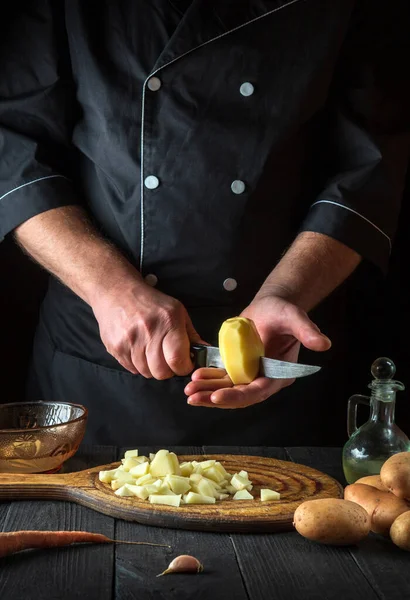 Professional Chef Cuts Raw Potatoes Pieces Knife Preparing Breakfast Dinner — Stockfoto
