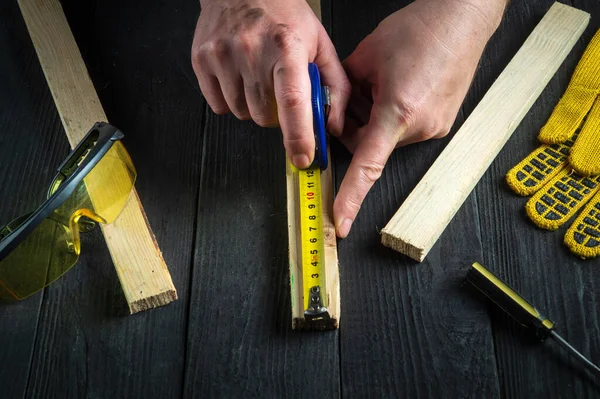 Stolarz Lub Stolarz Używa Taśmy Konstrukcyjnej Pomiaru Długości Kawałka Drewna — Zdjęcie stockowe