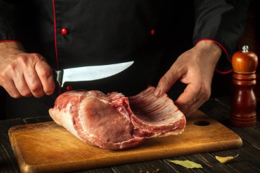 Kasap ızgaradan önce pirzola keser. Avrupa mutfağı. Otel için et yemeği fikri..