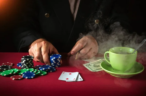 Lucky win for a player in a club game of poker. On the red table playing cards with a winning combination one pair.