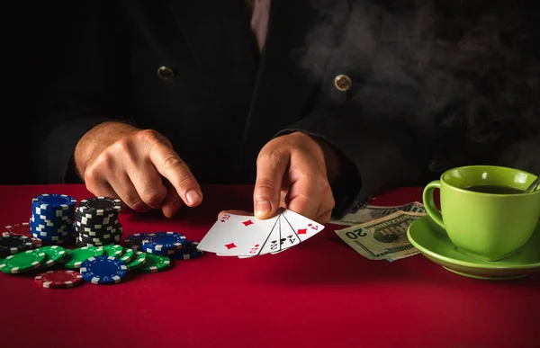 Lucky win in the poker club game. The player points with his finger at playing cards with a winning combination of two pairs.