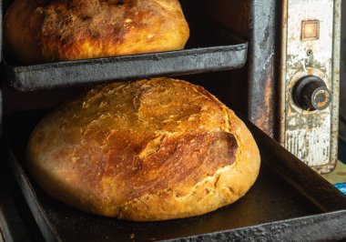Close-up of fresh artisan breads baked in vintage oven in cooking and eating concept. Ukrainian national dish