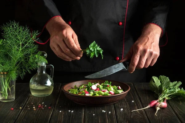 The cook prepares fresh vegetable salad. The idea of a diet breakfast or dinner