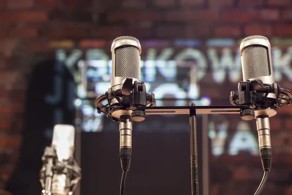 Microphones with a brick stage background — Stock Photo, Image