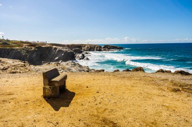 A bench with panoramic view on cliffs and beaches in Porto Covo, Alentejo, Portugal