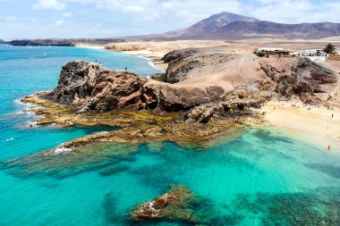 White sand and volcanic rocks at Papagayo Beach located on south end of Lanzarote, Canary Islands, Spain