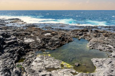 Charcones natural pools with green algae in Lanzarote, Canary Islands, Spain