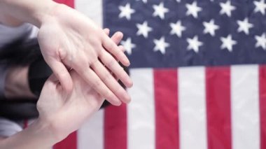 Serious girl stretch out her palm to camera says stop abortion American flag on background, vertical. Anti domestic violence, racism racial discrimination. Struggle for women rights, social problems