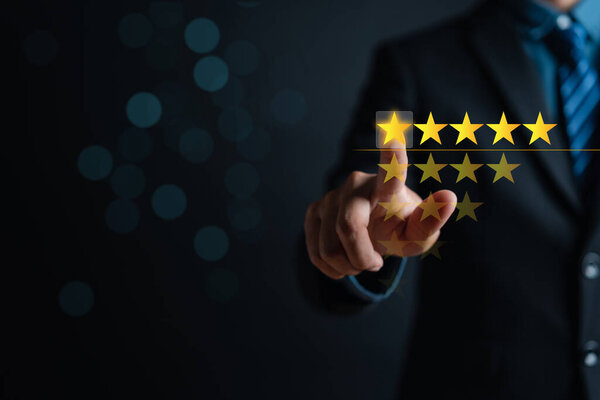 Customer businessman touching glowing illustration five stars rating service on virtual screen for satisfaction evaluation survey and review.