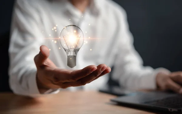 Great inspiration and innovation new beginning. creative smart thinking ideas and innovation. Businessman holding virtual lightbulb for presenting new ideas concept.