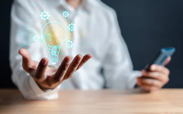 Great inspiration and innovation new beginning. creative smart thinking ideas and innovation. Businessman holding virtual lightbulb for presenting new ideas concept.