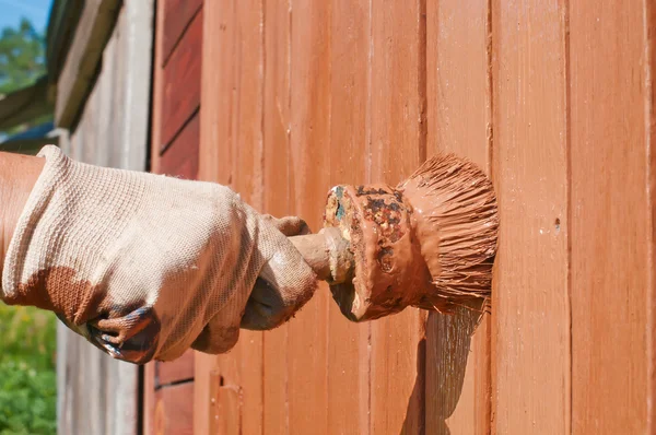 Hand mit dem Pinsel die Holztür bemalen — Stockfoto