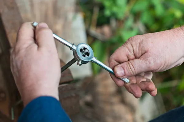 Close up tapping threads in stainless steel. — Stock Photo, Image