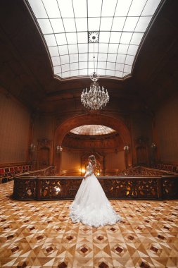 Düğün günü. Beyaz uzun elbiseli güzel gelin büyük tarihi Avrupa binasının içinde