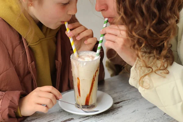 快乐的母亲和她可爱的少女在户外咖啡馆里喝着牛奶鸡尾酒 城市家庭周末快乐的家庭 — 图库照片