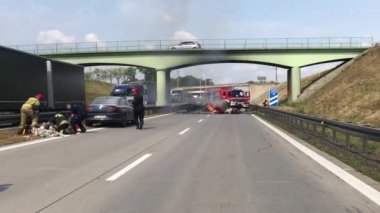 Car burns on highway road due to serious car crash of several cars. a rescue team of firefighters and paramedics is working at the scene of the accident. Wroclaw, Poland-February 6, 2020