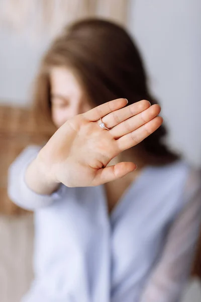 young woman shows a ring with diamond. The girl shows an engagement ring on her finger. she said yes. selective focus on hand