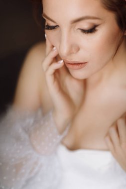 Güzellik konsepti Pembe bukleli parlak makyajlı, gösterişli, genç bir esmer kadının portresi. Stüdyo Çekimi, Kırpılmış. Yüz bakımı. Kozmetoloji, cilt bakımı ve kaplıca.