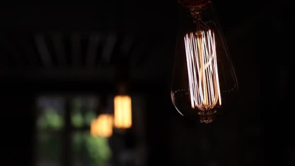 Close Retro Light Bulb Black Background Tungsten Filaments Glow Warm — Stock Video