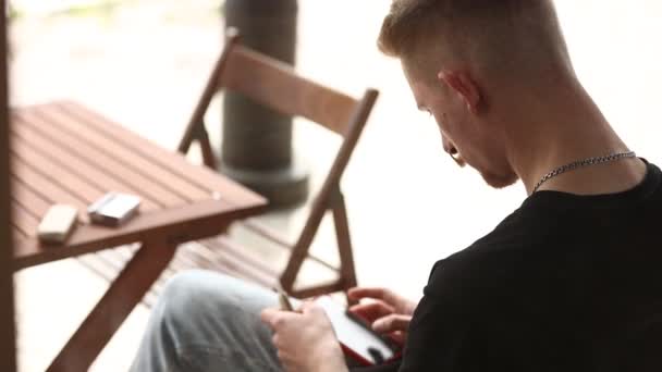 Young Stylish Man Sitting Table Vape Hand Using Smartphone Touching — Stockvideo
