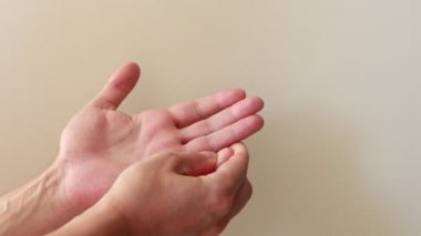 Close up of young male hands, doing point self hand massage for soothing and relaxing. Hand exercise with massaging on fingers and palms, Take care of health by exercising to relieve hand pain.