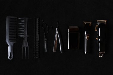 scissor, comb, brushes, straight razor, electric trimmer professional tools of hairdresser. Barber shop equipment set isolated on black background. Professional occupation, art, self-care concept