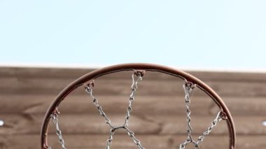 close up of basketball hoop. Basketball court outdoors, metal net and backboard for basket ball game outside. Recreational sport equipment on streetball field alfresco, playground on street