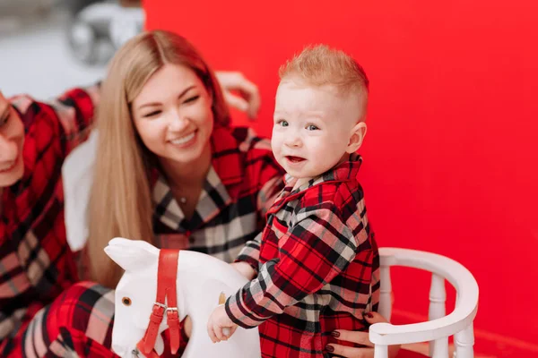 Smiling Young Mom Dad Playing Baby Boy Wooden Rocking Horse — Fotografia de Stock