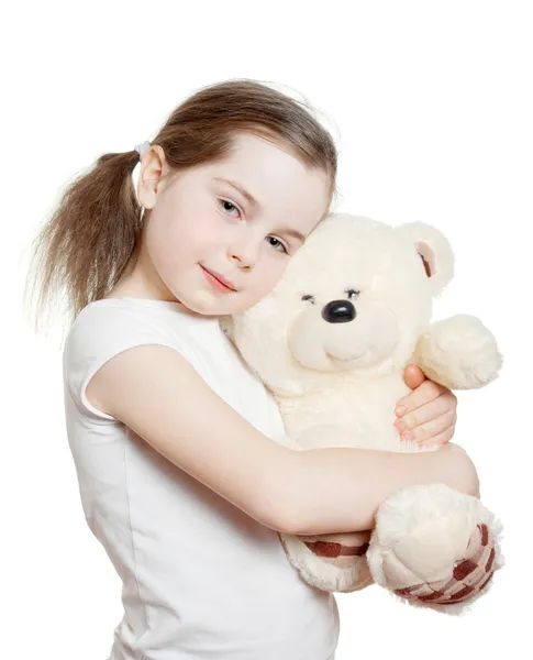 La bella bambina abbraccia un orsacchiotto Foto Stock Royalty Free