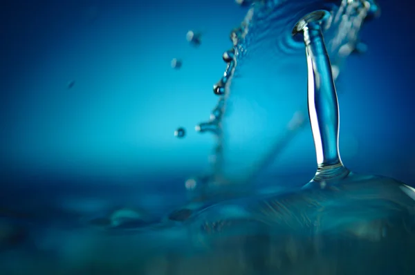 Blue water drop and splashes — Stock Photo, Image
