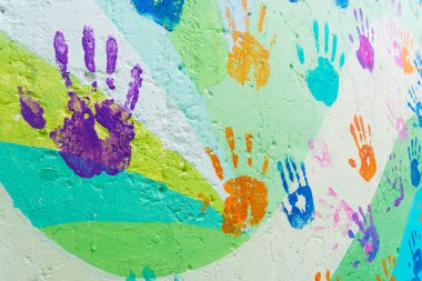 background made from color handprints of kids. Multicolor pattern for your design.