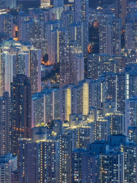 Aerial view of crowded residential building in Hong Kong city at night