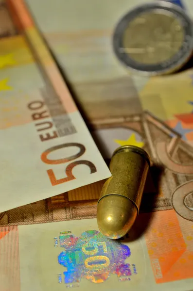 Bullet and money — Stock Photo, Image