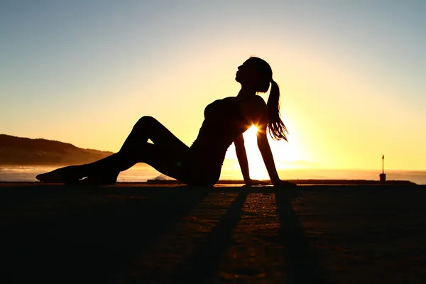 Sunrise lady sitting silhouette — Stock Photo, Image