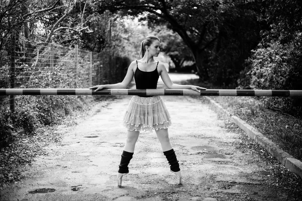 Ballerina holding boom gate — Stock Photo, Image