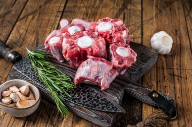 Çiğ Oxtail eti, tahta kesme tahtasında bıçakla kesilmiş. Ahşap arka plan. Üst görünüm