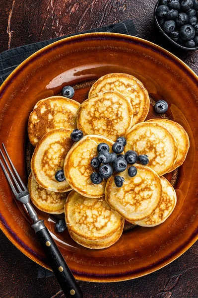 Piring dengan pancake dengan blueberry segar dan sirup. Latar belakang gelap. Tampilan Atas — Stok Foto