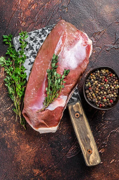 Filete de pechuga de pato fresco crudo en una cuchilla de carne. Fondo oscuro. Vista superior —  Fotos de Stock