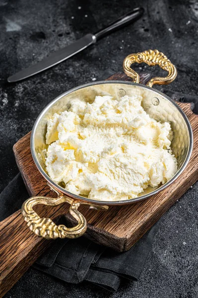 Kaymak Nata coagulada, creme de manteiga em uma panela rústica. Fundo preto. Vista superior — Fotografia de Stock