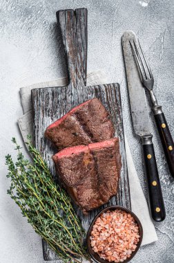 Kavrulmuş Omuz Üstü Bıçak ya da ahşap tahtada düz demir et bifteği. Beyaz arka plan. Üst Görünüm