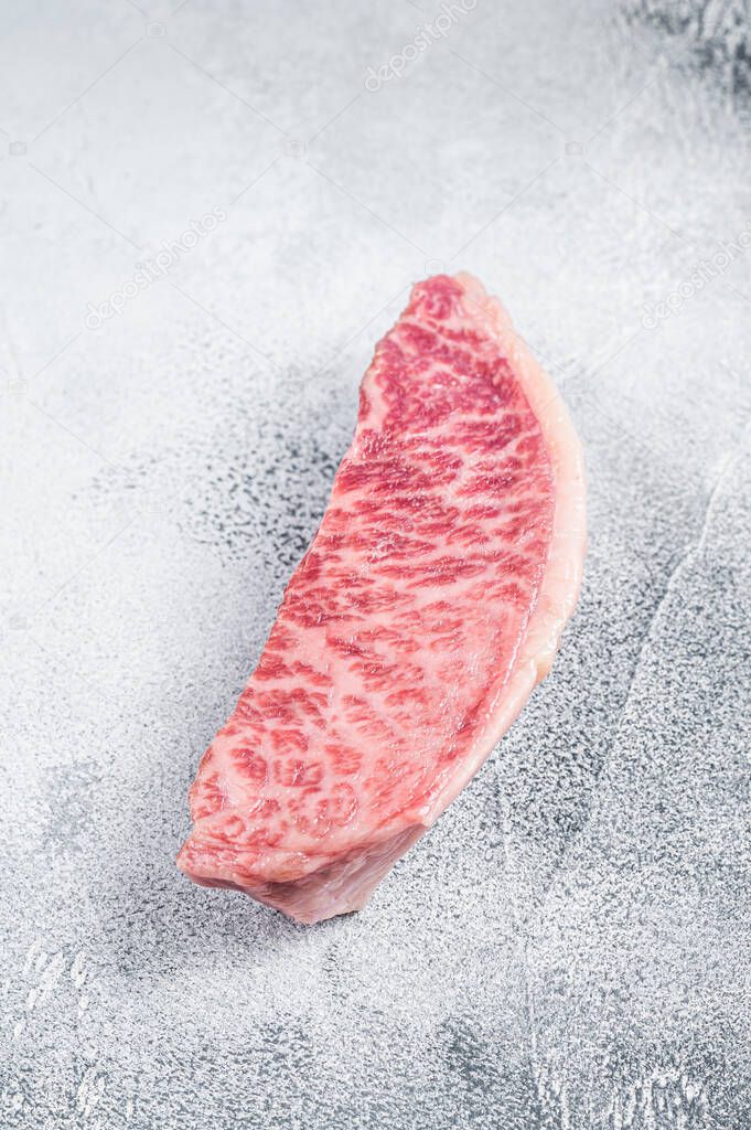 Raw wagyu rump sirloin steak, kobe beef meat. White background. Top view
