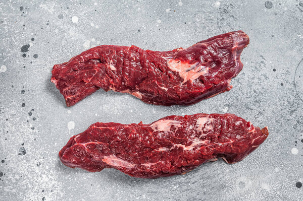 Machete steak raw cut or hanging tender cut. Gray background. Top view