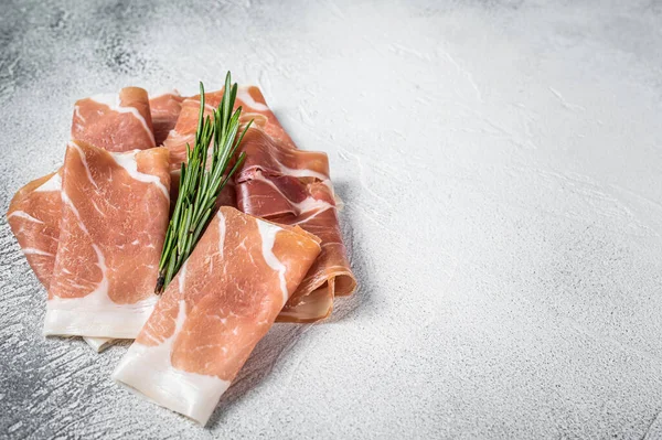 Italian prosciutto crudo parma ham on a table. White background. Top View. Copy space — Stock Photo, Image