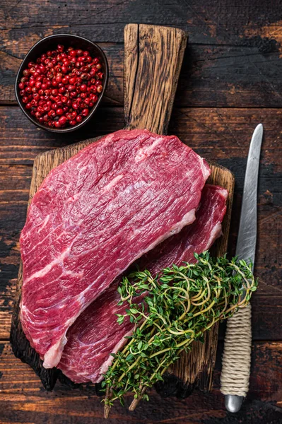 Raw top sirloin cap stek eller Picanha stek på träskiva med timjan. Mörk trä bakgrund. Ovanifrån — Stockfoto