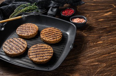 Vejetaryen usulü ızgara et köftesi, vejetaryen pirzola ve ızgara tava. Ahşap arka plan. Üst Manzara. Boşluğu kopyala