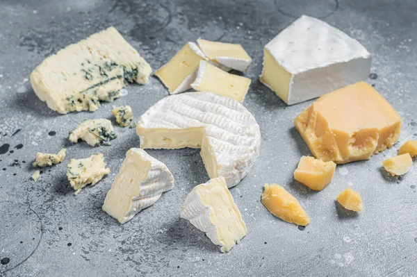 Sortiment an Käse. Camembert, Brie, Schimmelkäse, Parmesan. Grauer Hintergrund. Ansicht von oben — Stockfoto