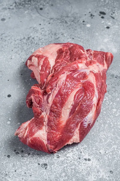 Boneless Raw lamb neck meat on a butcher table. Gray background. Top view — Stock fotografie