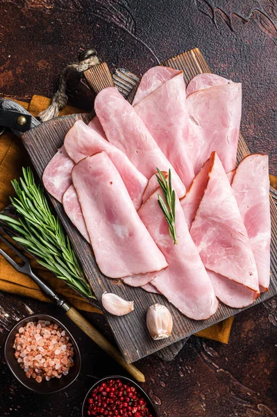 Flat slices of square sandwich ham with herbs. Dark background. Top view — Stockfoto
